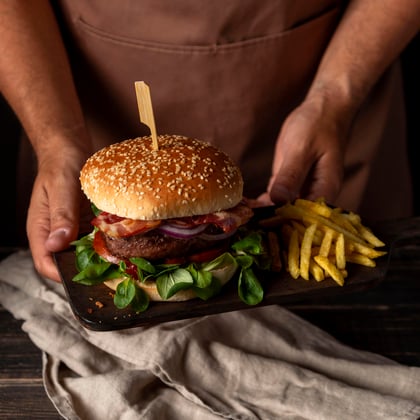 high-angle-man-holding-tray-with-burger-fries